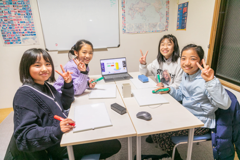 Girls smiling and giving peace signs