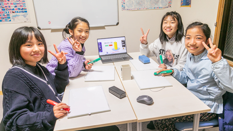 Girls smiling and giving peace signs