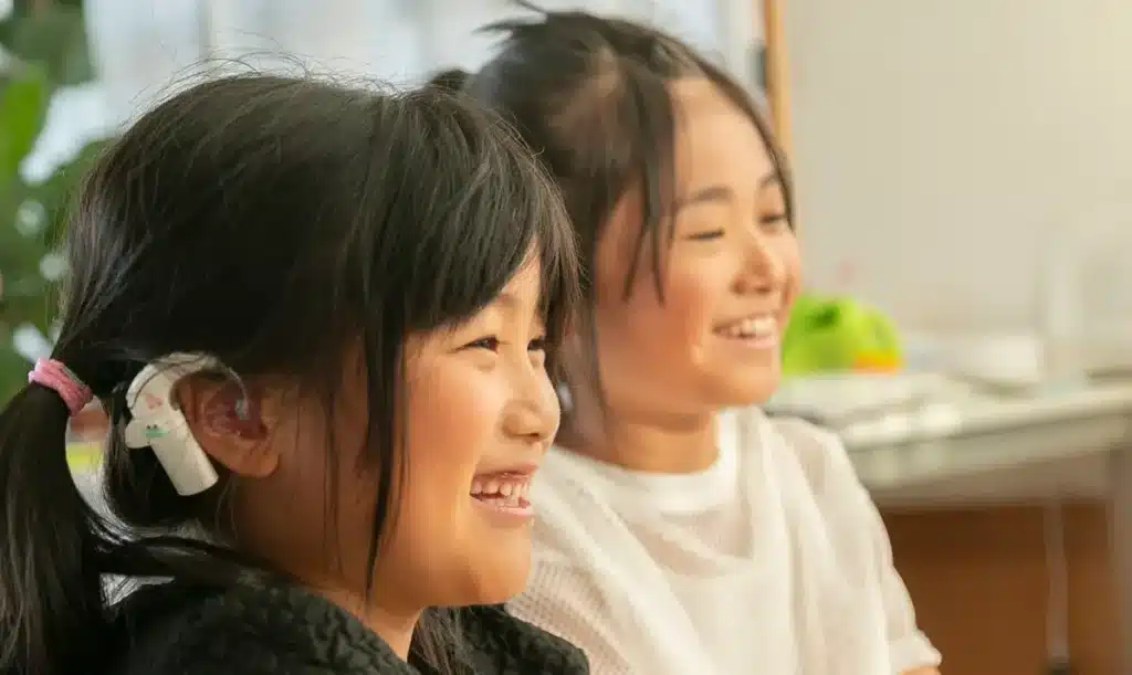 Two girls laughing during a lesson